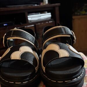 New never worn Dr Marten Black sandals with white daisy on them.
